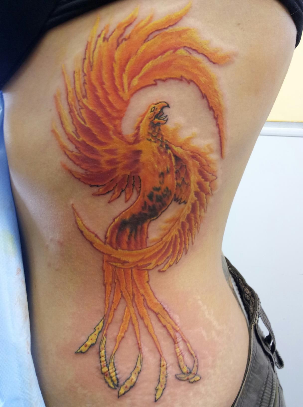 Татуировка Феникс на боку