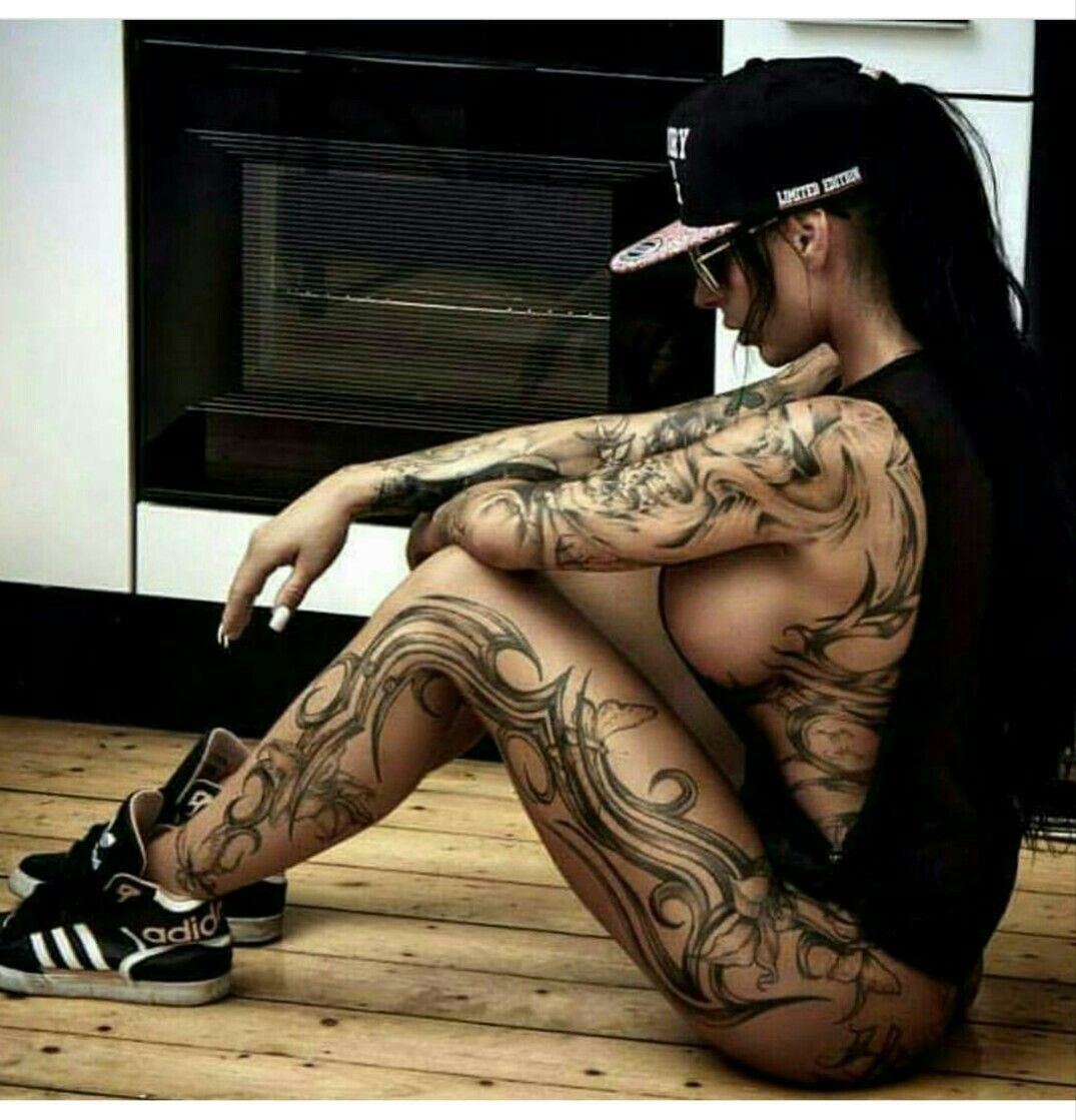 Татуированная Джесс показывает обнаженное тело на диване